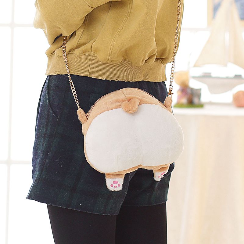 Image of a lady holding butt Corgi bag in the most adorable plush Corgi bum design