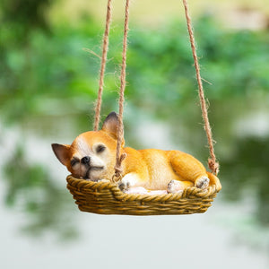 Image of a super cute sleeping and hanging Chihuahua garden statue
