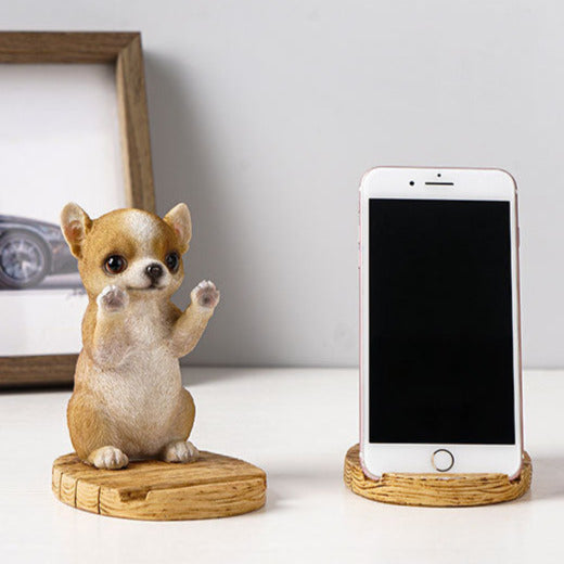 Image of a super cute Chihuahua phone holder made of resin with an iphone placed on it