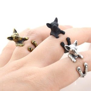 Image of three finger wrap Chihuahua rings on the finger of a person in three colors including Antique Silver, Bronze, and Black Gunmetal