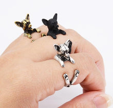 Load image into Gallery viewer, Image of three finger wrap smiling Chihuahua rings on the finger of a person in three colors including Antique Silver, Bronze, and Black Gunmetal