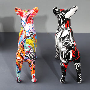 Back image of two multicolor graffiti design Chihuahua statues