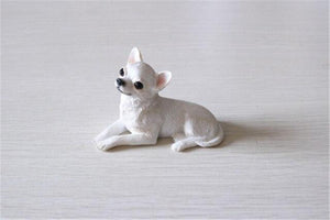 Image of a beautiful sitting Chihuahua figurine in the color White