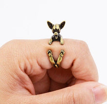 Load image into Gallery viewer, Image of a finger wrap smiling Chihuahua ring on the finger of a person in the color Antique Bronze