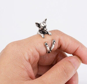 Image of a finger wrap smiling Chihuahua ring on the finger of a person in the color Antique Silver