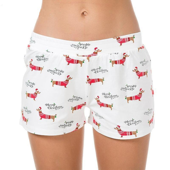 Image of a lady wearing dachshund shorts with a merry christmas dachshund design