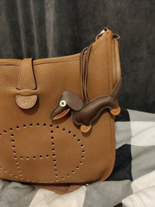 Image of a coffee color dachsund accessory on a handbag