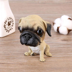 Image of a Pug bobblehead sitting on the floor