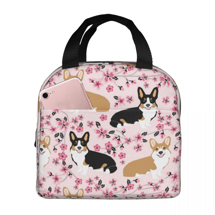 Image of an insulated Corgi lunch bag with exterior pocket in cherry blosson corgi design