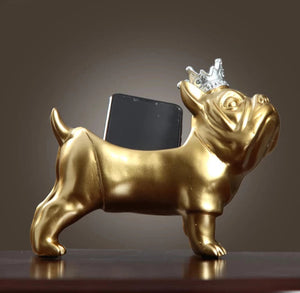 Image of two french bulldog statues with storage in gold with cellphone inside
