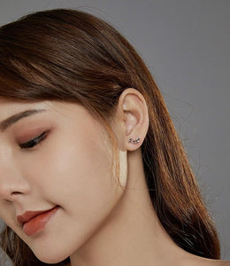 image of lady wearing dachshund silver stud earrings