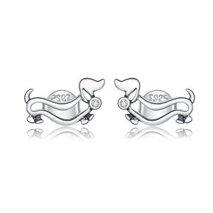 Image of two silver sausage dog earrings