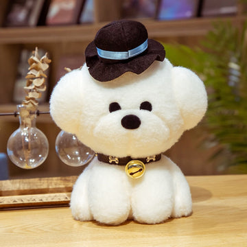 This image shows a cute Bichon Frise Stuffed Animal Plush Toy with a black hat in it's neck and sitting on the table.