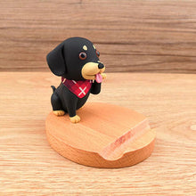 Load image into Gallery viewer, Image of a Dachshund mobile phone holder on a wooden table