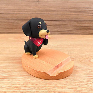 Image of a Dachshund mobile phone holder on a wooden table