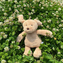 Load image into Gallery viewer, the image shows a cute plush golden retriever soft toy laying in a flower garden looking adorable.