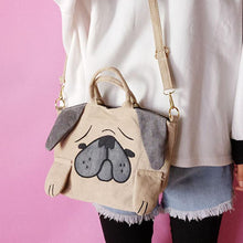 Load image into Gallery viewer, Image of a pug holding pug sling bag