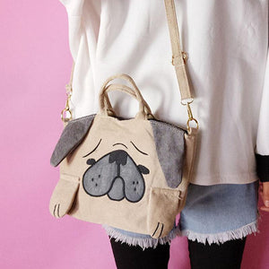 Image of a pug holding pug sling bag