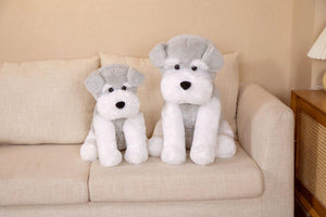 this image shows two Cutest Schnauzer Stuffed Animal Plush Toy of different sizes sitting on the sofa looking adorable.