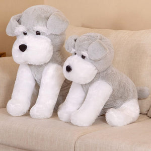 this image shows the side view of two Cutest Schnauzer Stuffed Animal Plush Toy of different sizes sitting on the sofa looking adorable.