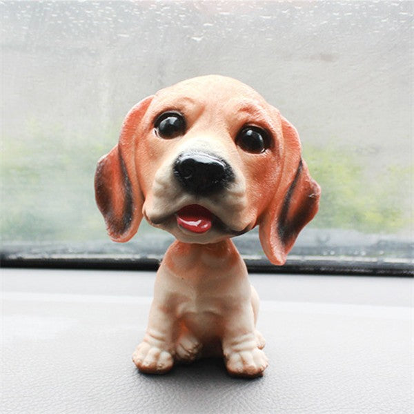 Image of a beagle bobblehead in a car