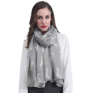Image of a girl wearing a beautful Dachshund scarf in the color light grey with infinite Dachshunds design