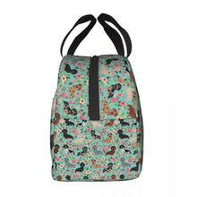 Load image into Gallery viewer, Side image of an insulated green color Dachshund lunch bag with exterior pocket in bloom design