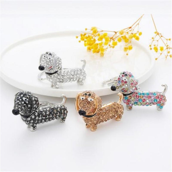 Image of stone-studded Dachshund keychains in four colors including Black, White, Brown, and Multicolor.
