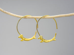 Image of two golden dachshund hoop earrings