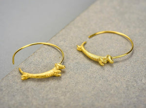 Image of two sausage dog earrings
