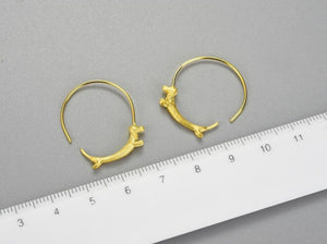 image of two golden dachshund hoop earrings