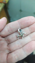 Load image into Gallery viewer, Image of a small silver Dachshund pendant in the shape of Dachshund on the hand of a person