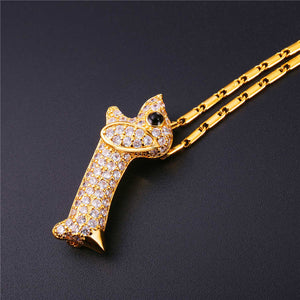 Image of a stone studded weiner dog necklace in the color gold