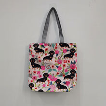 Load image into Gallery viewer, Image of a Sausage dog tote bag in a most adorable sausage dog in bloom design
