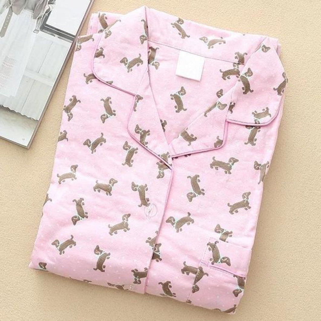 Image of a pink color folded Dachshund Pajama set with an infinite dachshund print design