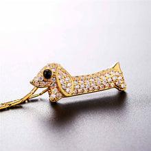 Load image into Gallery viewer, Image of a stone studded dachshund pendant necklace in the color gold