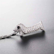 Load image into Gallery viewer, Image of a stone studded dachshund pendant necklace in the color silver