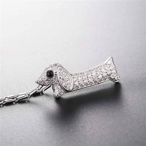 Image of a stone studded dachshund pendant necklace in the color silver