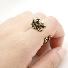 Load image into Gallery viewer, Image of a finger wrap Dachshund ring on the finger of a person in the color Antique Bronze