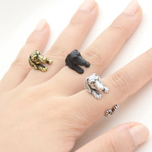 Load image into Gallery viewer, Image of three finger wrap Dachshund rings on the finger of a person in three colors including Antique Silver, Bronze, and Black Gunmetal