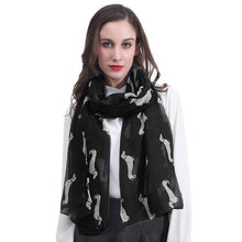Load image into Gallery viewer, Image of a girl wearing a beautful Dachshund scarf in the color black with infinite Dachshunds design