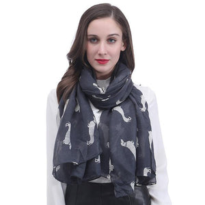 Image of a girl wearing a beautful Dachshund scarf in the color dark grey with infinite Dachshunds design