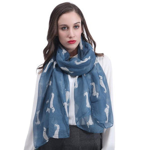 Image of a girl wearing a beautful Dachshund scarf in the color denim blue with infinite Dachshunds design