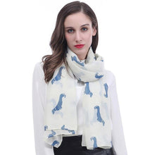 Load image into Gallery viewer, Image of a girl wearing a beautful Dachshund scarf in the color white cream with infinite Dachshunds design