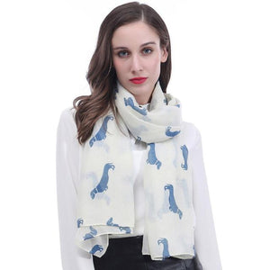 Image of a girl wearing a beautful Dachshund scarf in the color white cream with infinite Dachshunds design