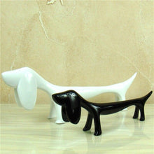 Load image into Gallery viewer, Image of twin Dachshund statues in the color black and white, made of resin