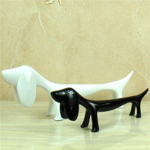 Image of twin Dachshund statues in the color black and white, made of resin