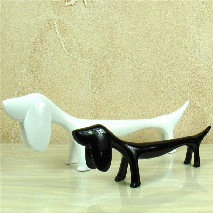 Image of twin Dachshund statues in the color black and white, made of resin