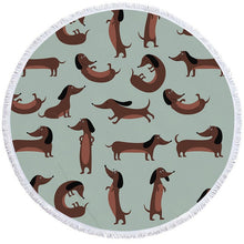Load image into Gallery viewer, Image of a round dachshund towel with chocolate dachshunds on green-blue background