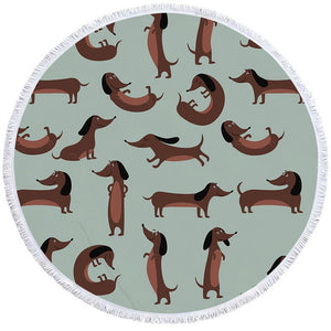 Image of a round dachshund towel with chocolate dachshunds on green-blue background